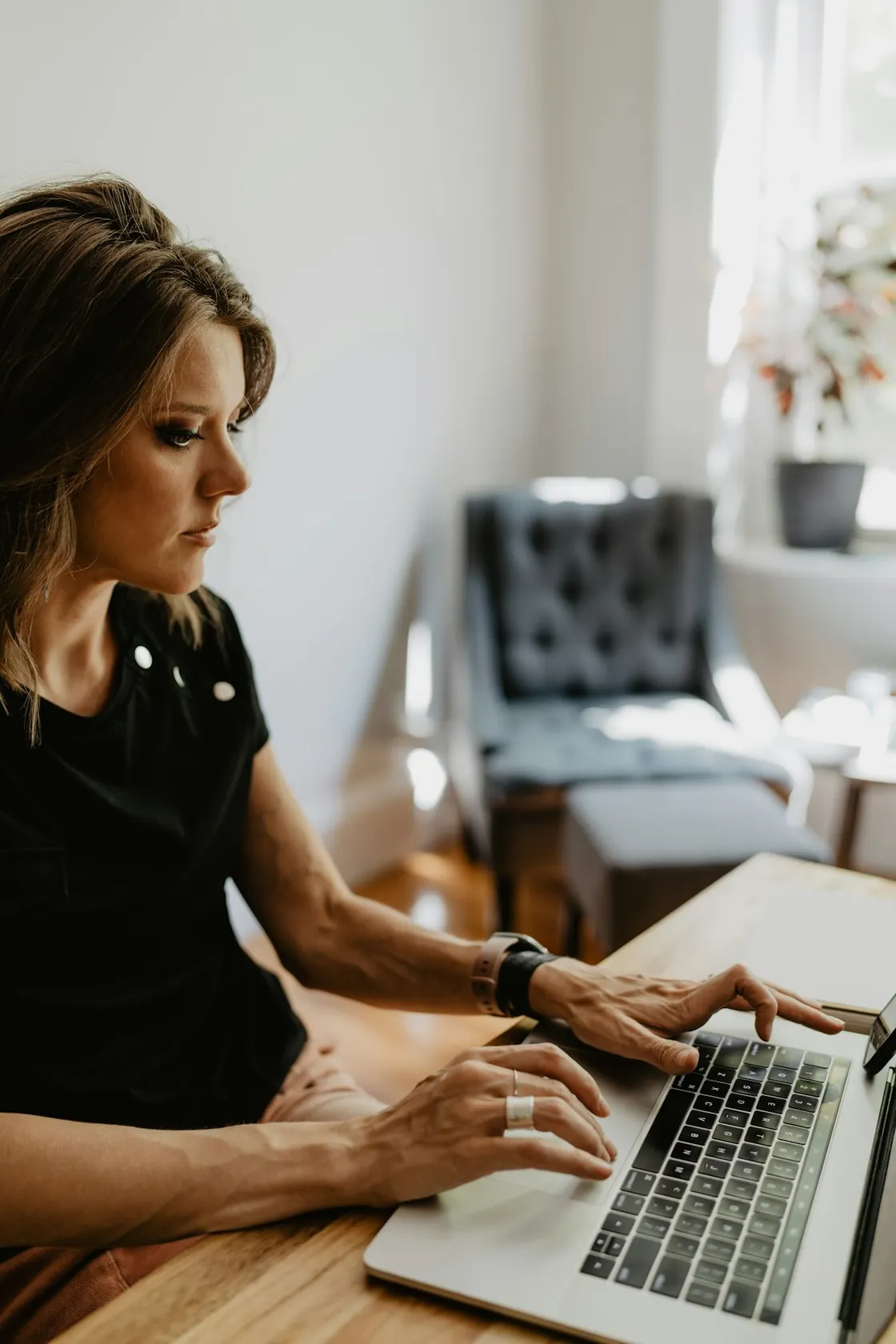 A person checks a laptop at home.
